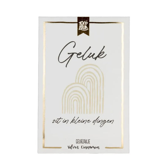 wit geurzakje met gouden details en met de tekst geluk zit in kleine dingen