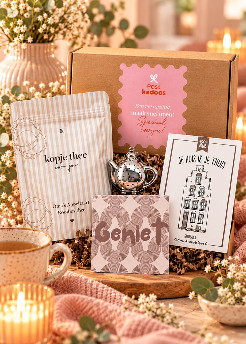 Origineel cadeau voor een nieuw huis met thee, thee-ei, onderzetter en geurzakje, feestelijk gepresenteerd met een Postkadoos cadeaudoos.